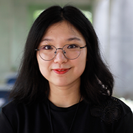 Keke Wu, an Asian woman with shoulder-length dark hair, wearing glasses and a black shirt, facing the camera with a neutral background.